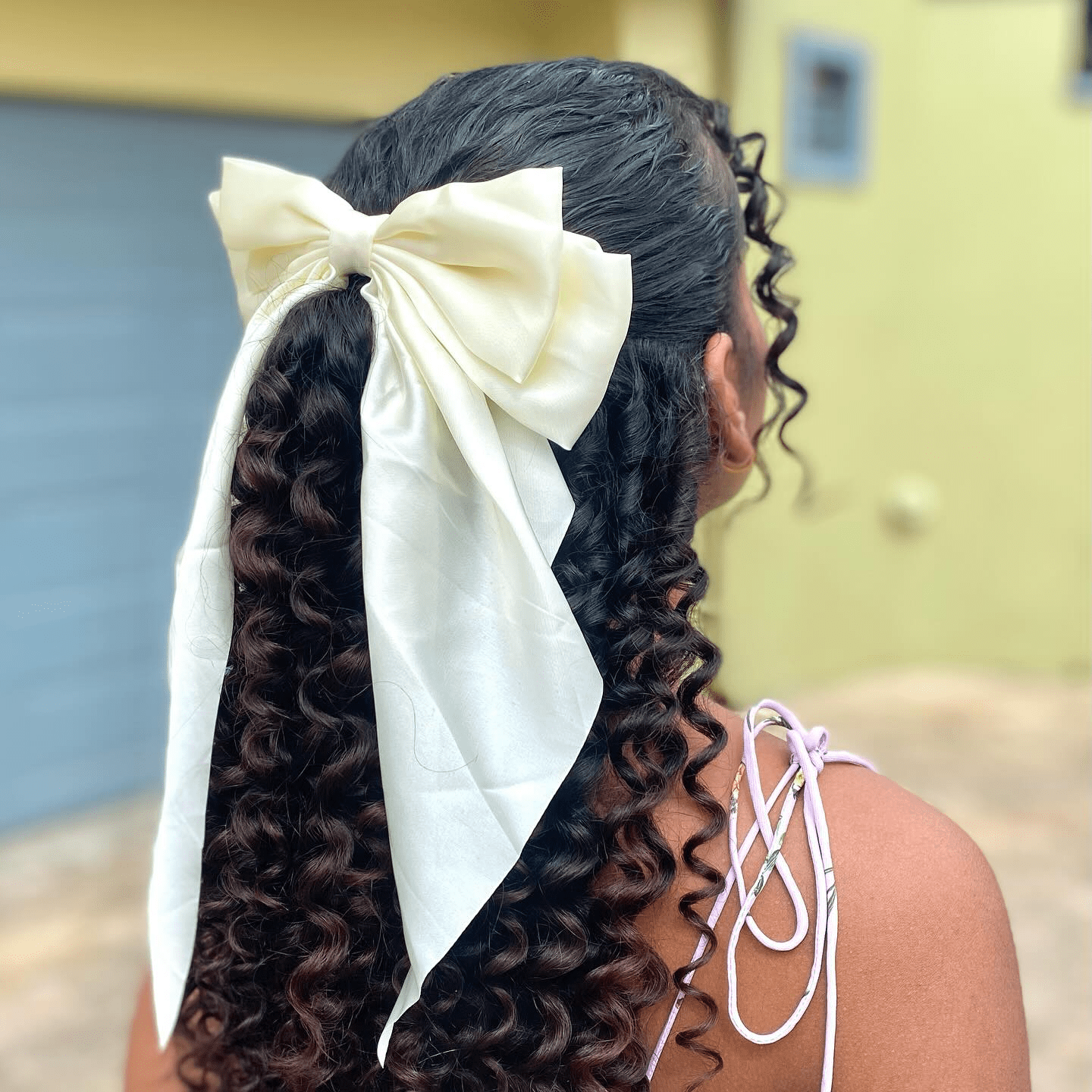 Curly Elegance with Whimsical Bow